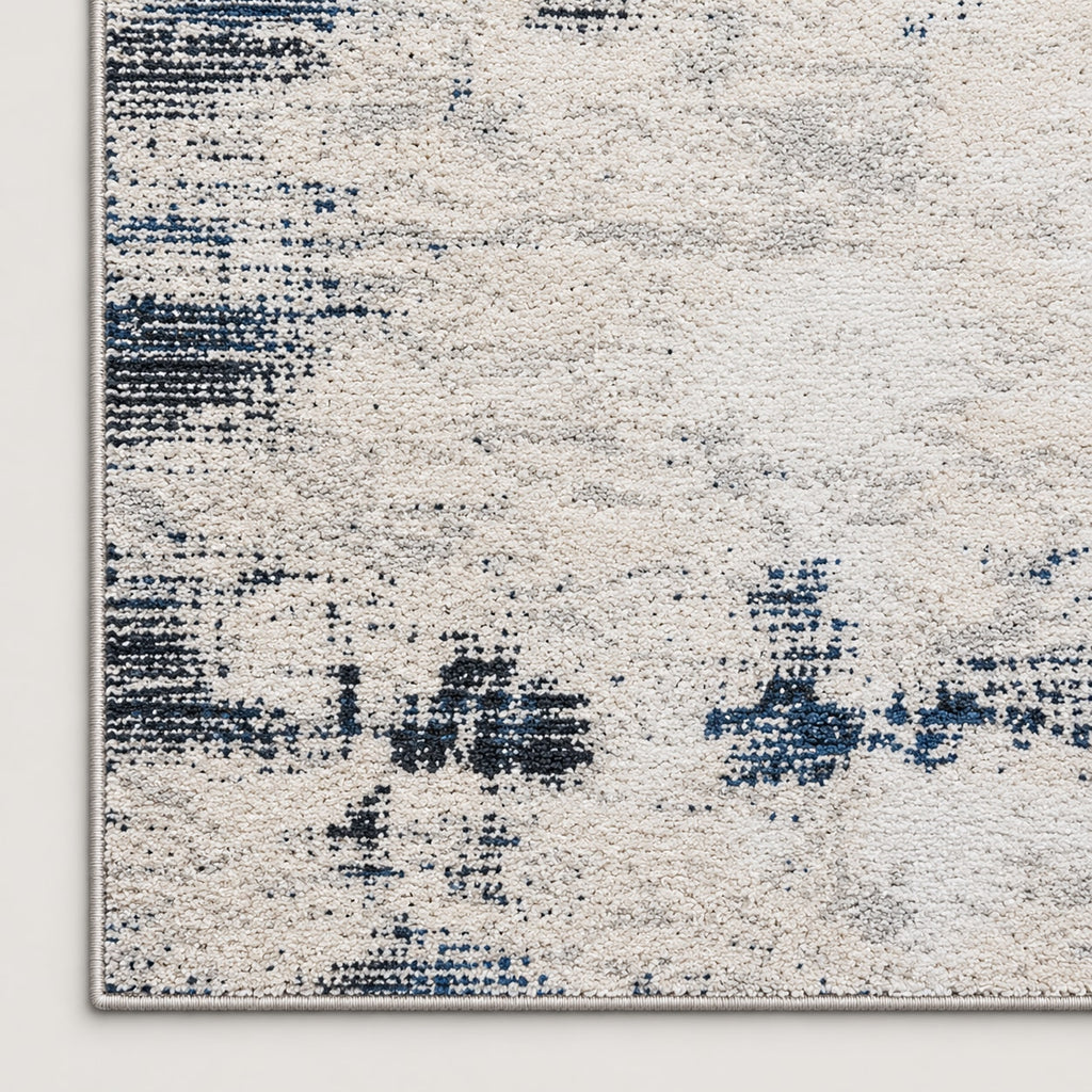 Tapis Brume ivoire et bleu nuit — coin et texture sur fond clair