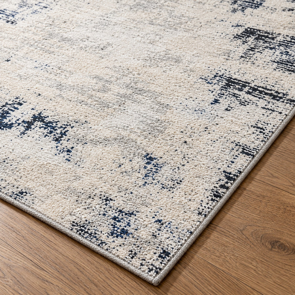 Tapis Brume ivoire et bleu nuit — détail de la bordure et de l'épaisseur