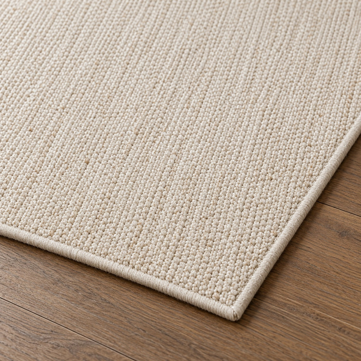 Tapis Dune ivoire — détail de la bordure et de l'épaisseur