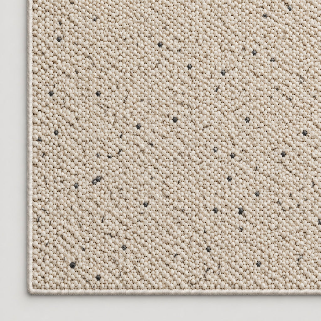 Tapis Galet beige moucheté — coin et texture sur fond clair