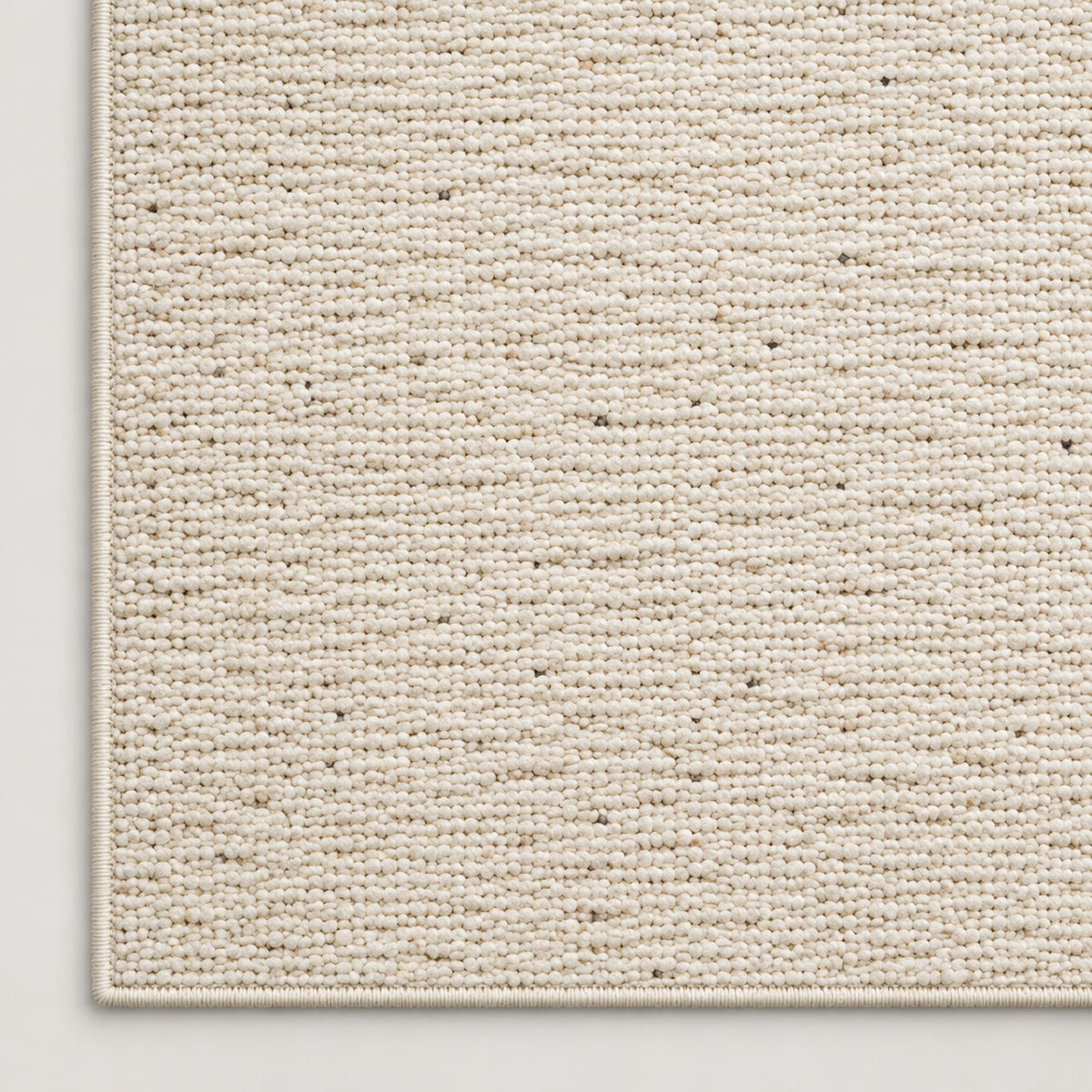 Tapis Grès écru chiné — coin et texture sur fond clair