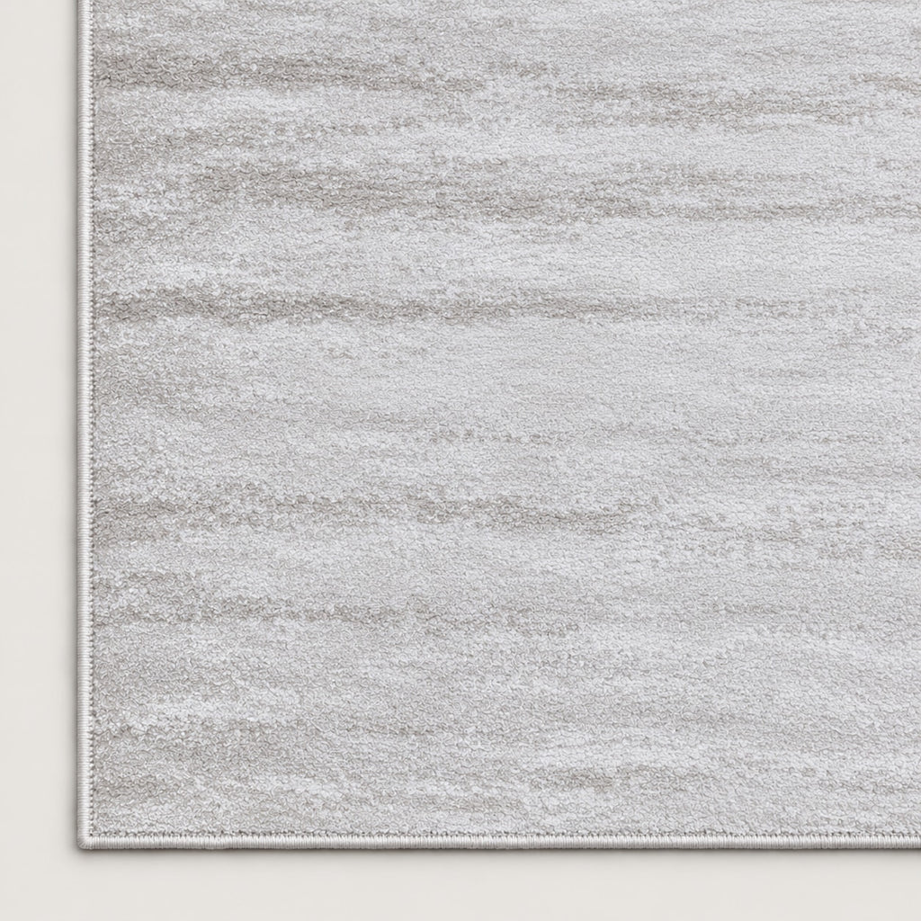 Tapis Opale blanc argenté — coin et texture sur fond clair