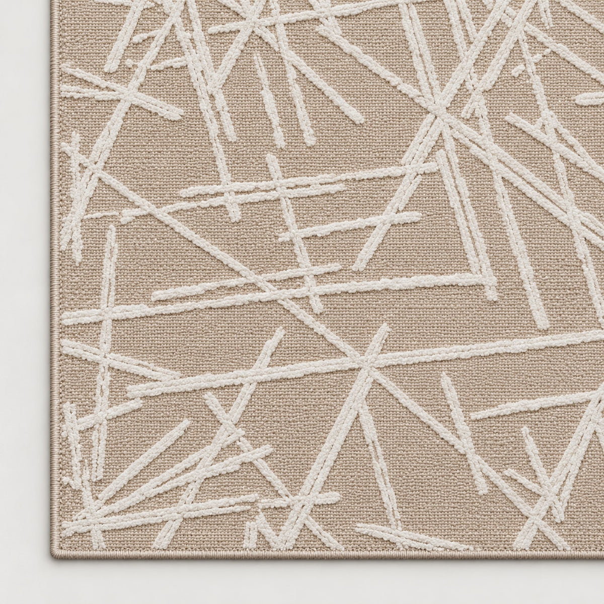 Tapis Tracé beige — coin et texture sur fond clair